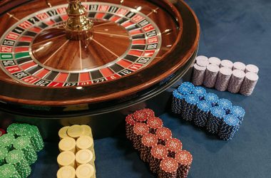 Roulette beside several stacked casino chips in different colors